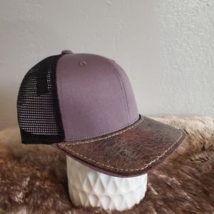 Ball cap with hand-sewn leather patch on brim